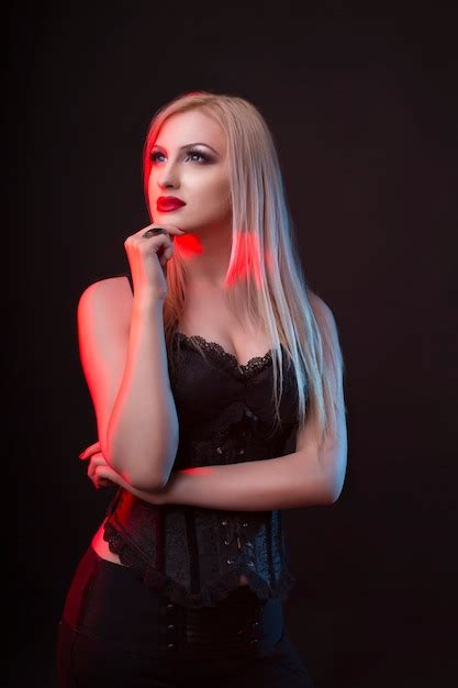 Premium Photo Seductive Blonde Woman In A Corset With Red And Blue Light