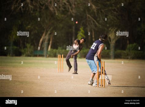 Two Boys Playing Cricket In A Playground New Delhi India Stock Photo