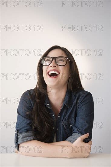 caucasian woman wearing eyeglasses laughing photo12 tetra images jgi jamie grill
