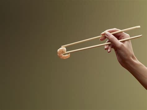 Stiffen your hand for a firm grip. How to Eat With Chopsticks