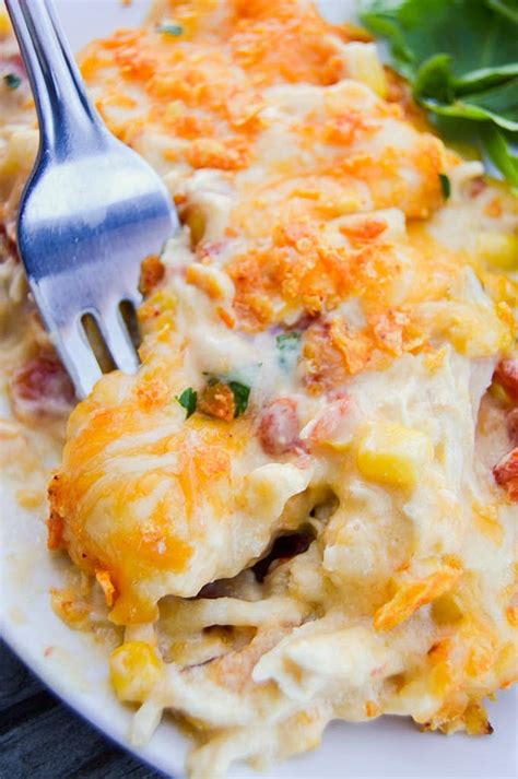 In a large bowl, mix together the chicken, rotel, cream cheese, sour cream, taco seasoning, and cream of chicken soup. Creamy Cheesy Dorito Chicken Casserole | YellowBlissRoad.com