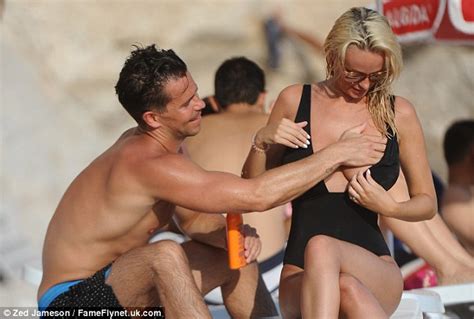 Rhian Sugden Puts On Busty Display In A Very Plunging Swimsuit As She