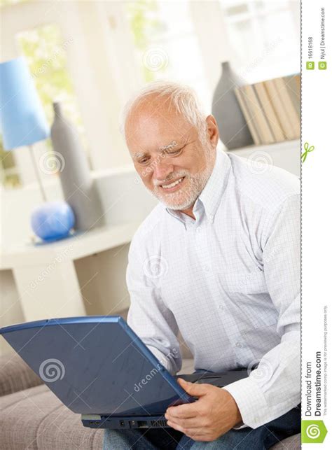 Smiling Elderly Man Looking At Computer Screen Royalty