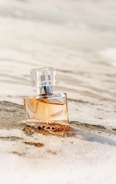 Premium Photo A Bottle Of Perfume On The Seashore Is Enveloped In A