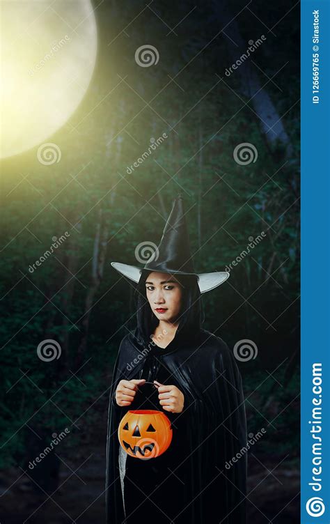 Woman In Black Scary Witch Halloween Costume With Moonlight In A Stock