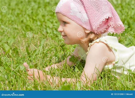 A Little Girl Lying On A Green Lawn Stock Photo Image Of Looking