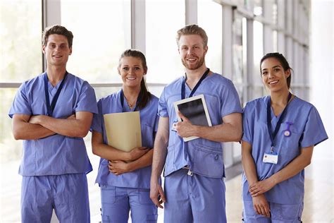 Group Portrait Of Healthcare Workers In Hospital Corridor Rose