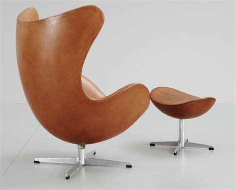 An Arne Jacobsen Brown Leather Egg Chair And Ottoman Fritz Hansen