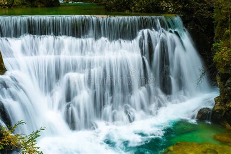 Autumn Forest Colors With Beautiful Turquoise Waterfall Outdoor In