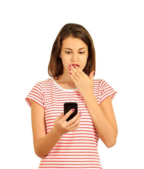 Portrait If A Shocked Young Girl Looking At Mobile Phone Emotional Girl Isolated On White