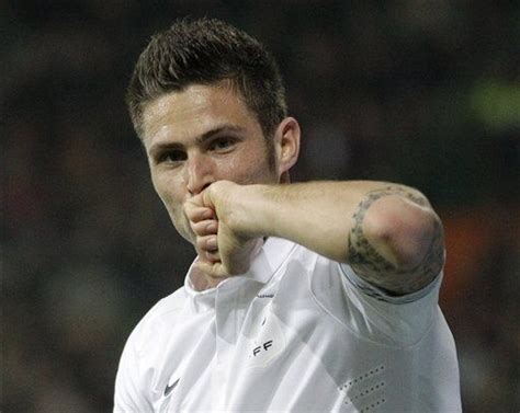 On his right arm he bears a tattoo which reads: Olivier Giroud Tattoo Right Arm