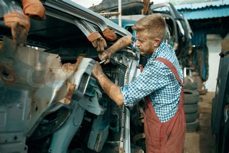 Male Repairman Poses On Car Junkyard Stock Image Colourbox