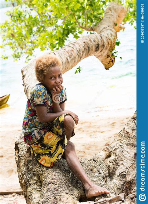 Solomon Island Shy Girl With Blond Hair And Dark Skin Sitting On Tree