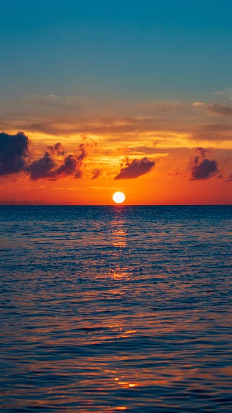 Download 720x1280 Wallpaper Skyline Sea Calm Body Of Water Sunset