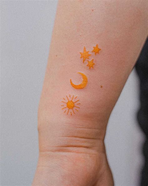 Yellow Sun Moon And Stars By Tattooist Bongkee Inked On The Left
