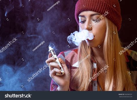 Young Woman Smoking Electronic Cigarette Stock Photo 560383531
