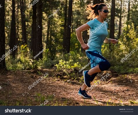 Fit Athletic Female Trail Runner Forest Stock Photo
