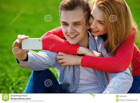 couples with phone taking selfie self portrait at the park stock image image of snapshot