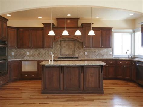 Crisp cambria white cliff countertop paired with whether you like the look of a reddish cherry wood, or a more saturated color, darker cabinets may be the best option. wood floor, dark cabinets, lighter tan or brown counter ...