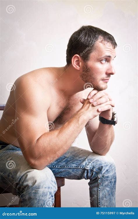 portrait of thoughtful attractive man sitting on a chair stock image image of perfect male