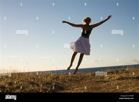 Pretty Blond Jumping Stock Photo Alamy