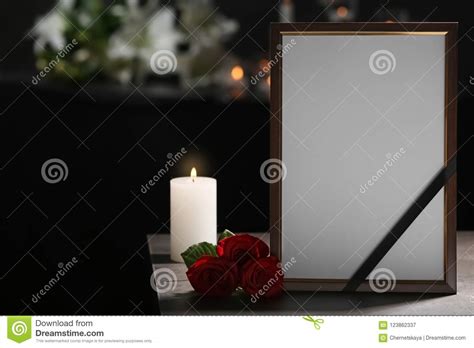 Funeral Photo Frame With Ribbon White Rose And Candle On Background