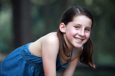 Brunette Girl With Freckles And Pigtails Wearing Denim Dress And