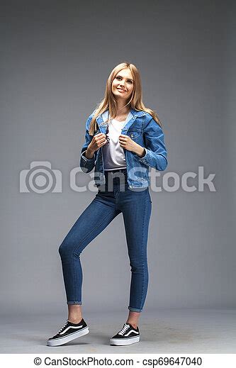 Beautiful Sexy Blonde Woman Dressed In A Denim Jacket And Blue Jeans Fashion Model In Jeans