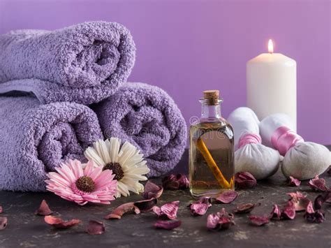 Spa Treatment And Massage Products With Towels And Oil On Stone With