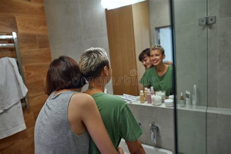 Lesbian Girls Hug And Look In Mirror At Bathroom Stock Photo Image Of