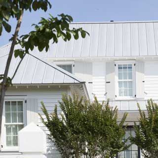 Metal roof colors influence the energy of a building, so careful selection can ultimately save money on energy bills. UECo - White house with gray metal roof and gray shutters | Transitional Architecture ...