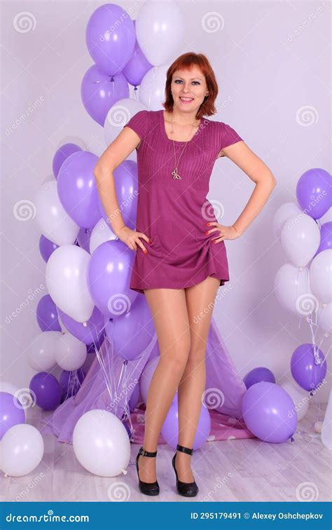 Long Legged Redhead Girl In Shiny Stockings And Miniress Posing At Balloons Stock Image Image