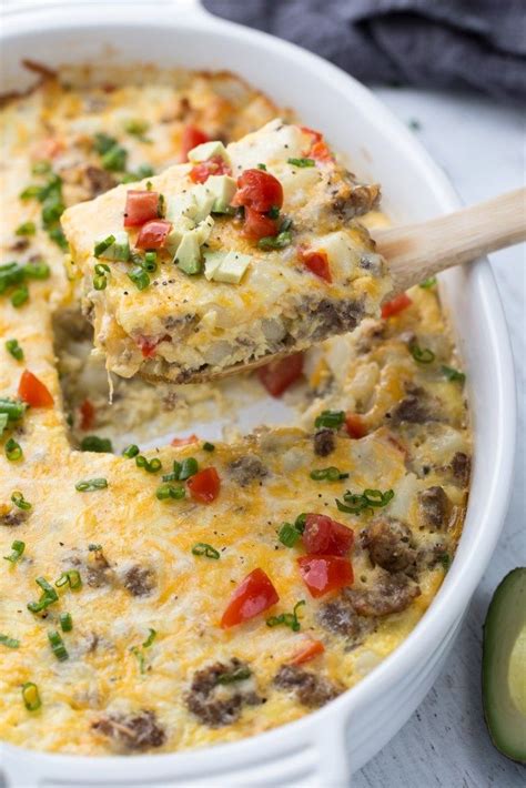 Sausage And Potato Casserole In Cheesy Eggs Served With Tomatoes And