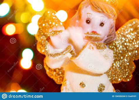 Angel With Gold Wings On Background Of Bokeh Lights Christmas New