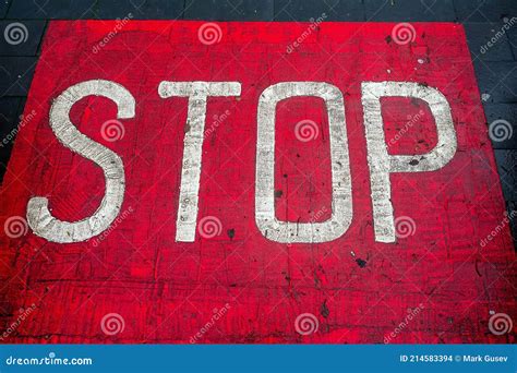 White Color Stop Sign On A Red Asphalt Surface Warning Information For