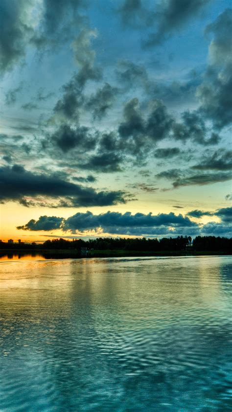 Cloudy Blue Sky Above Calm Body Of Water During Sunset 4k