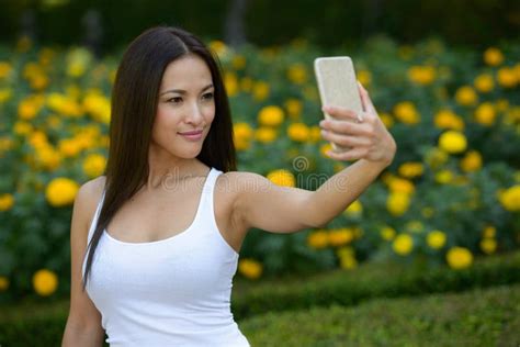 Beautiful Asian Woman Taking Selfie At The Park Outdoors Stock Image