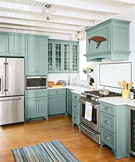 The cabinet hardware and barstools add extra dashes of black. From Musty to Must-See Kitchen | Teal kitchen, Glasses and ...