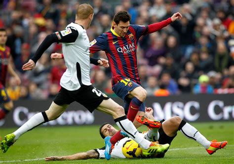 Barcelonas Lionel Messi Vies The Ball Against Valencias
