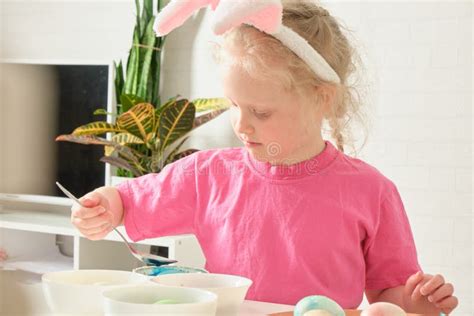 Little Girl In Bunny Ears Easter Concept Table With Easter Eggs