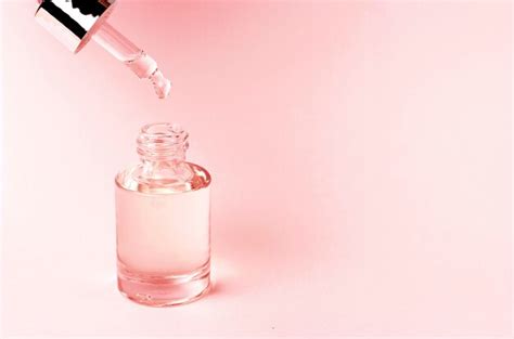 Premium Photo Serum And Dropper On A Pink Background Close Up