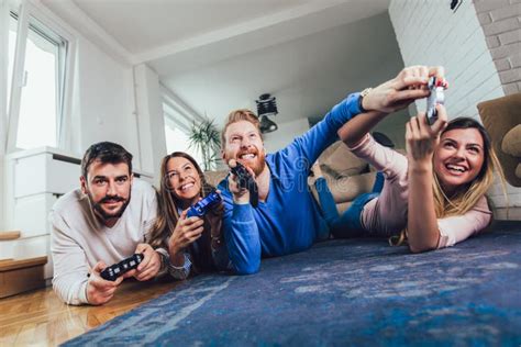 Group Of Friends Play Video Games Together At Home Stock Image Image Of Controller Game