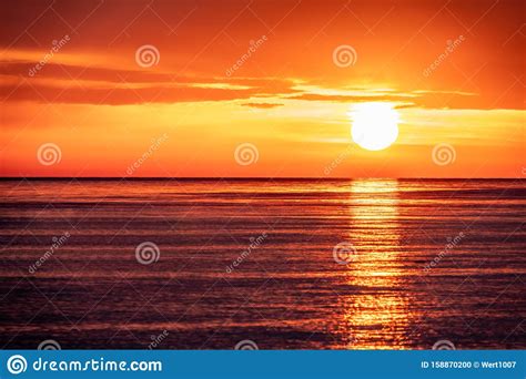 Beautiful Red And Orange Sunset Over The Sea. The Sun Goes Down Over The Sea Stock Photo - Image ...