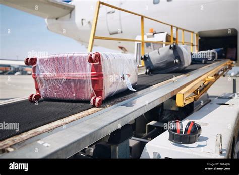 Loading Of Luggage To Airplane Suitcases On Conveyor Belt To Plane