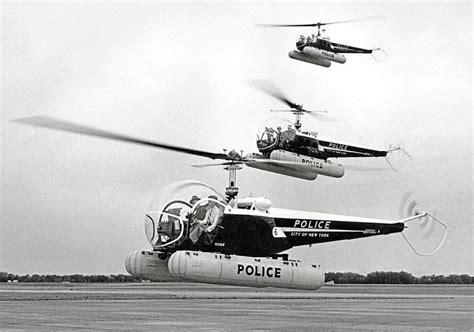 Black And White Photograph Of Three Police Helicopters Flying In Formation Over An Airport Runway