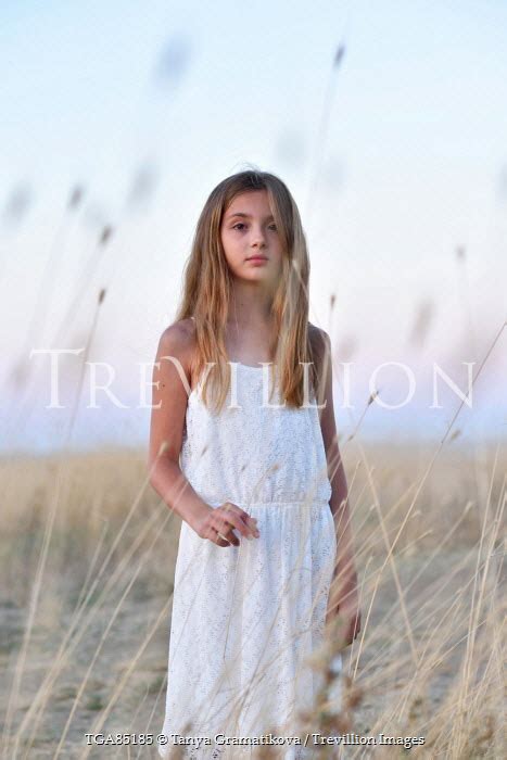 Young Blonde Girl In Countryside At Dusk By Tanya Gramatikova