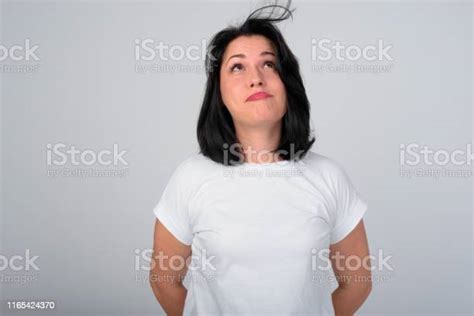 Beautiful Woman Blowing Hair Against White Background Stock Photo