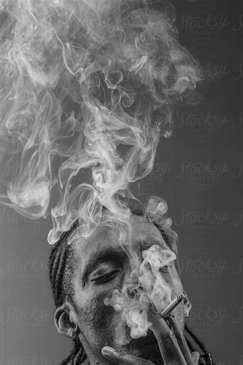 Black Man Smokes A Cigarette Thick Smoke Del Colaborador De Stocksy