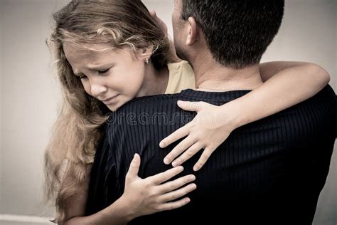 Portrait Of One Sad Daughter Hugging His Father Stock Photo Image