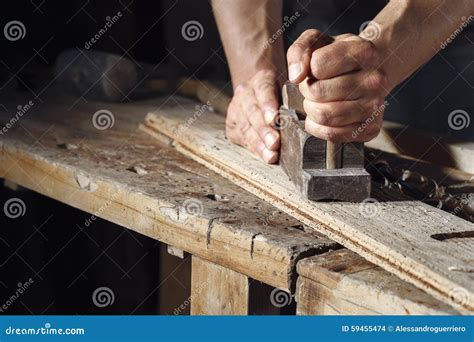 Carpenter Planing A Plank Of Wood With A Hand Plane Stock Photo Image